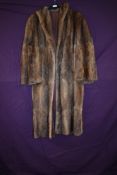 A full length vintage mink coat, around a medium size.