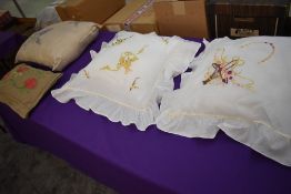 A selection of cushions, beautifully embroidered and made out of vintage and antique fabrics.