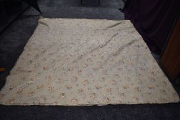 An early 20th century satin quilt with floral design of champagne ground having soutache type thread