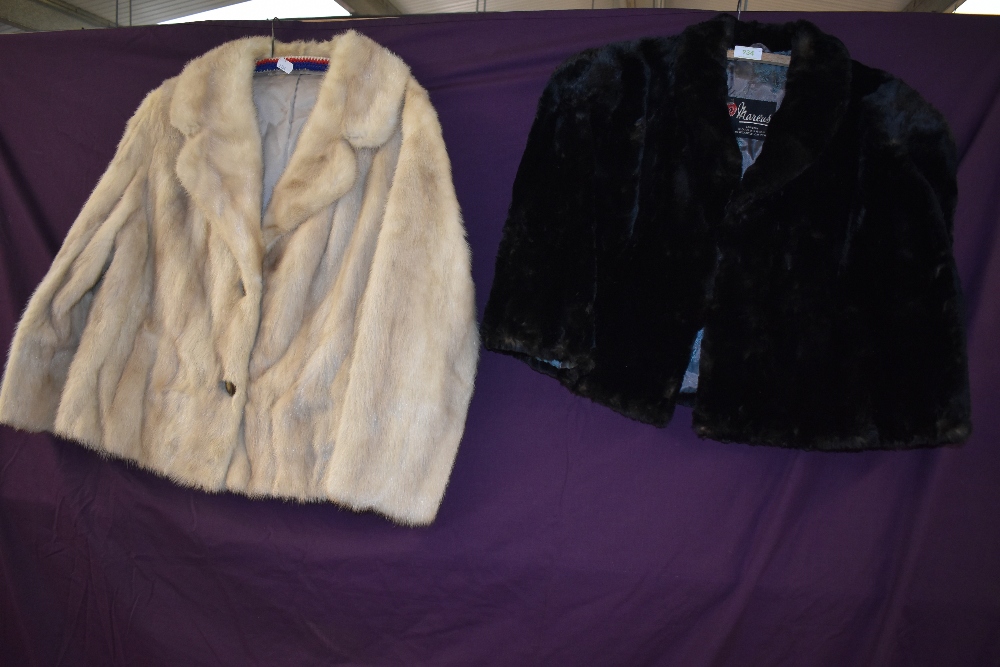 A vintage black moleskin cape and a blonde mink jacket.