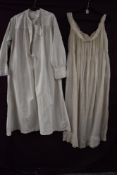 A Victorian cotton nightdress having broderie anglais detailing an long sleeves and similar short
