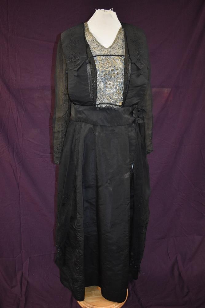 An early 20th century black taffeta tea dress having panels of georgette to sides with st