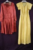 A 1940s full length yellow gown and a 1930s day dress.