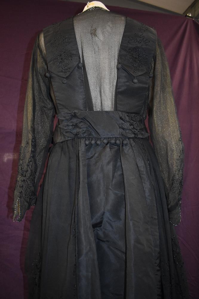An early 20th century black taffeta tea dress having panels of georgette to sides with st - Image 6 of 10