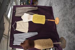 A selection of vintage clothing including mini skirts and cigarette pants with side metal zips.