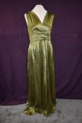 A moss green late 40s/50s full length gown having side zipper, gathers to waist and v neckline.