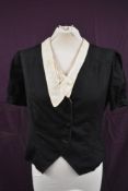 A black 1930s short sleeved jacket having puff sleeve with slit detailing,lovely deco buttons and