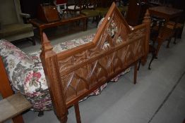 A Gothic style carved headboard, width approx. 153cm