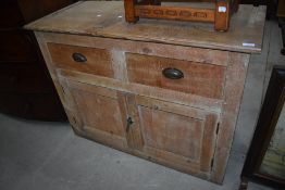 A traditional stripped pine dresser base, having two drawers over double cupboard, width approx.