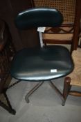 A vintage swivel office chair, industrial style, labelled Tansad pure posture chair
