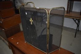 A brass tri fold fire guardc, coal bucket and scuttle