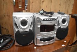 A Panasonic CD Stereo System , with 5 CD changer and twin cassette decks, model SA-AK18, includes