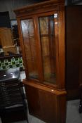 A reproduction yew wood corner display cabinet with cupboard under, from the William Bartlett