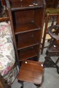 An early 20th Century oak narrow bookshelf and a small stained frame occasional table
