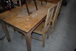 A rustic pine farmhouse kitchen table and four similar rail back chairs, table dimensions approx.