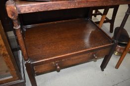 An early 20th Century oak tea trolley of large proportions with drawer to lower tier, dimensions