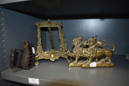 A pair of brass cast book ends of two rampant lions, a similar brass cast picture frame and a