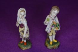 A pair of early Victorian figure studies of fruit sellers bearing a circle mark to base possibly