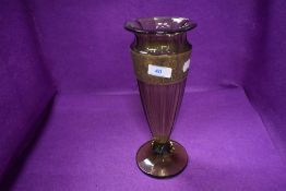 A hand made Bohemian glass vase with brass Roman border signed to base