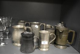 A selection of pewter tankards and mugs including a spouted pint mug