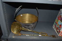 A selection of brass fire side items including jam pan toasting fork and strainer