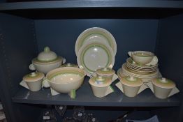 A stunning art deco part dinner service in a green and yellow colour way by Clarice Cliff from the