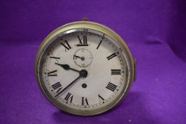 An early 20th century ships style port hole clock having a brass case
