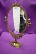 A vintage brass dressing table mirror.