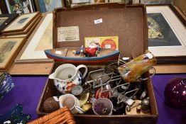 A selection of curios and trinkets including toy boat and postage scales