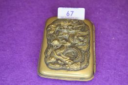 A Japanese cigarette or card case having embossed dragon motif and makers mark to reverse