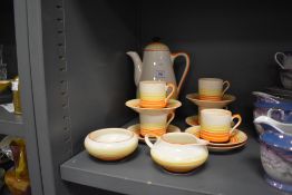 An art deco part coffee set by Grays Pottery in an orange and yellow banded pattern