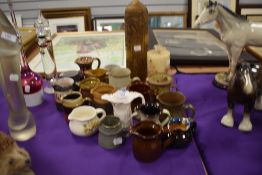 A selection of ceramic water milk snd cream jugs most being salt glazed