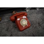 A vintage red plastic PO telephone