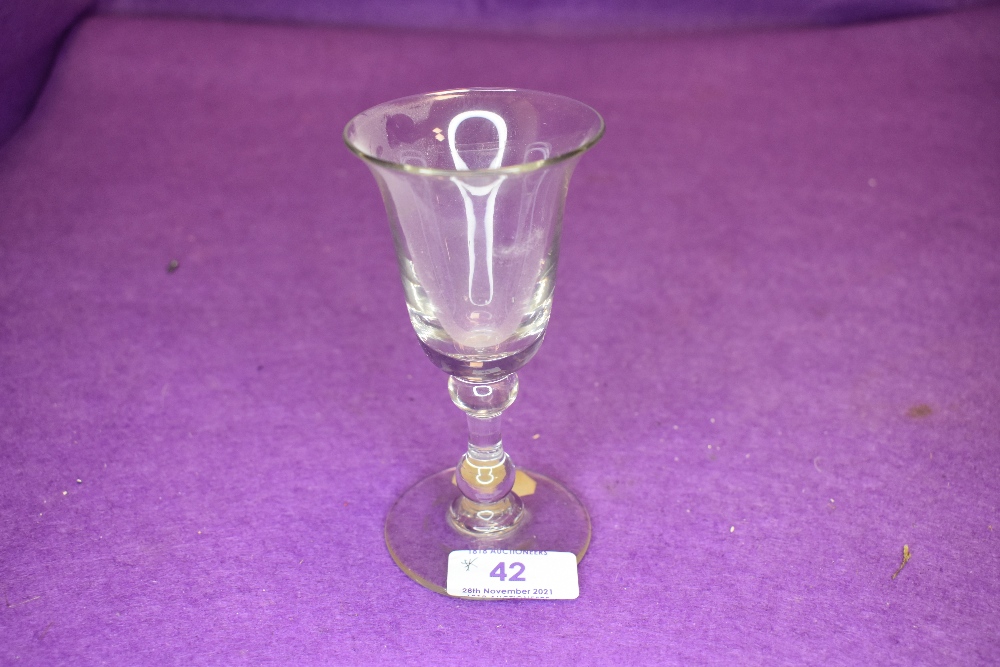 A deep bowl wine glass with two knops to stem.