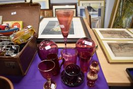 A selection of cranberry glass items including vase, bowl and glass