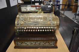 A late Edwardian shop keepers till having decorative embossed brass work marked National