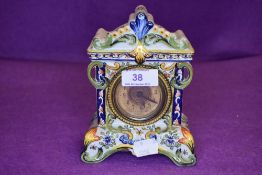 A vintage ceramic mantel clock having continental quimper styling and brass face with bevelled glass