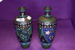 A pair of Japanese or similar cloisonne vase in green and blue hues