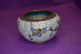 A small squat cloisonne bowl with flower decoration