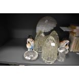 Three glass light shades a pair of porcelian dog figures and a stone cut decoration