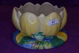 A Clarice Cliff lily pad bowl in blue and yellow, marked for Newport Pottery to underside.