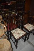 A set of four (two plus two) early 20th Century wave rail back dining chairs