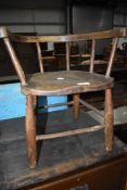 A vintage childs stool having spindle and rail back, width approx. 49cm