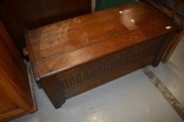 A reproduction chest, dough form having chip carved decoration to front, width approx. 105cm