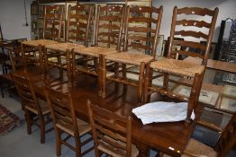 A set of ten (eight plus two) good quality reproduction ladder back chairs having rush seats