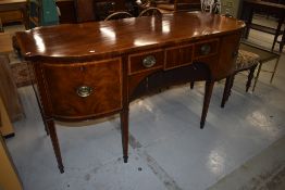 A Regency mahogany sideboard having shaped front, right hand drawer fitted for bottles, width