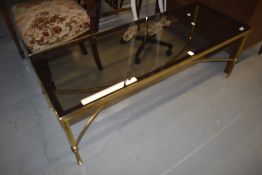 A nice quality Regency style brass coffee table having glass top, approx. 120 x 46cm