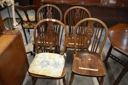 A set of four traditional wheelback kitchen dining chairs