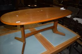 A 20th Century oval coffee table on whale tail type legs, width approx. 106cm