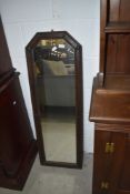 An early to mid 20th Century oak slender wall mirror having canted corner to top